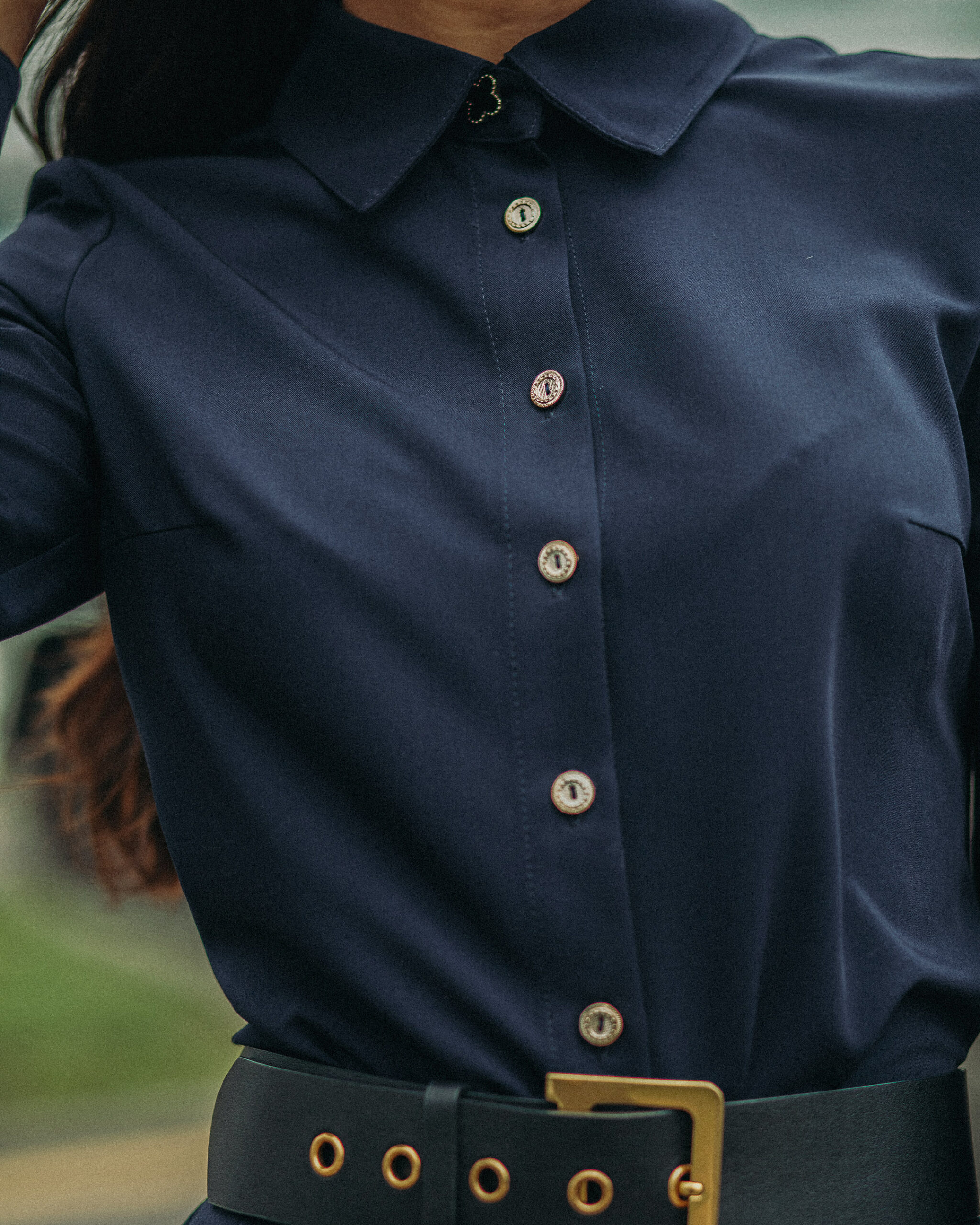 close-up-lady-wearing-black-dress-with-stylish-leather-strap-while-standing-outdoors-female-fashion
